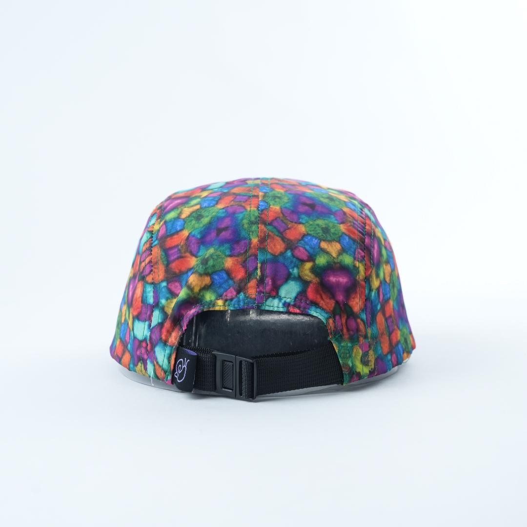 Savvy Munk Grass Water 5-Panel Hat displayed flat, highlighting the vibrant psychedelic print