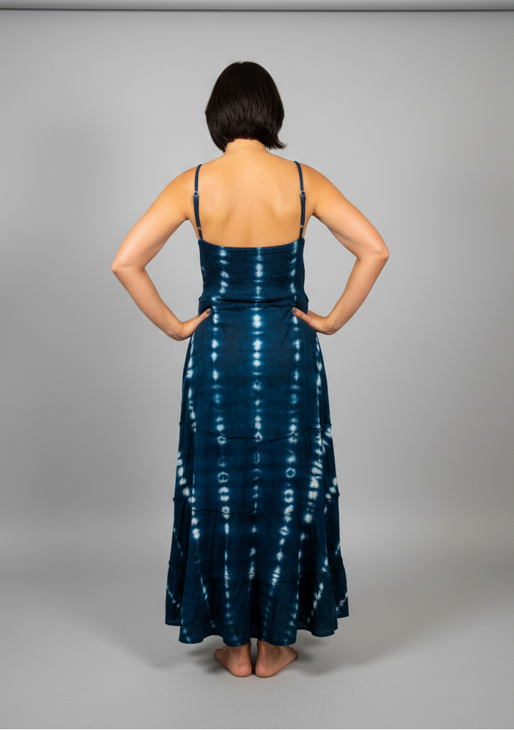 Model wearing the Savvy Munk Indigo Waves Hand-Dyed Tiered Maxi Dress, showcasing the flowing silhouette, vibrant handcrafted patterns, and artisan cotton quality in a studio setting.