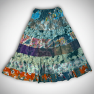 Savvy Munk Prism Flow Tiered Boho Maxi Skirt displayed flat, highlighting vibrant handcrafted batik, tie-dye, and patchwork patterns on 100% artisan cotton from Nepal.