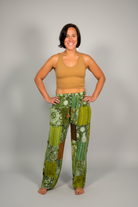 Savvy Munk model wearing Sage Sunburst Patchwork Drawstring Pants handcrafted in Nepal, paired with a tan crop top.