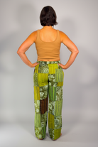 Savvy Munk model April wearing Sage sunburst patchwork pants. Rear view 