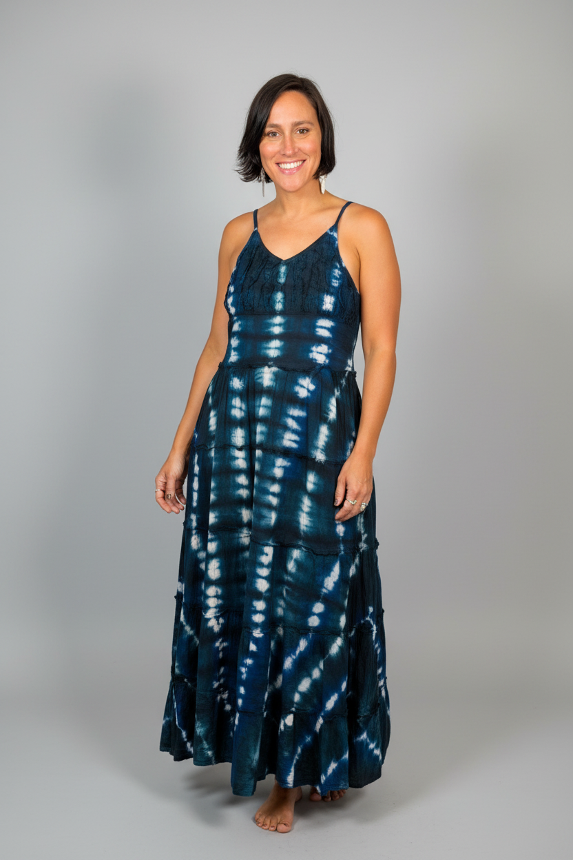 Model wearing the Savvy Munk Indigo Waves Hand-Dyed Tiered Maxi Dress, showcasing the flowing silhouette, vibrant handcrafted patterns, and artisan cotton quality in a studio setting.
