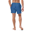 Model wearing the Savvy Munk Donut Remix - Recycled Swim Trunks, highlighting the bold graphic print and relaxed festival-ready fit in a lifestyle setting.