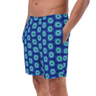 Model wearing the Savvy Munk Donut Remix - Recycled Swim Trunks, highlighting the bold graphic print and relaxed festival-ready fit in a lifestyle setting.